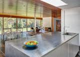 The home was originally built with an enclosed service kitchen, however Joeb Moore's renovation replaced it with an open, modern kitchen that connects to the living area.