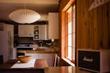 A Herman Miller saucer bubble pendant light hangs in the dining area of the Canyon Cabin AirBnb.&nbsp;