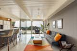 The open kitchen overlooks a casual living area with a wall of glass that provides a view of the spectacular backyard and beyond.&nbsp;