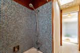 The shower of the shared second bathroom has been updated with a brightly tiled shower.&nbsp;
