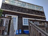 Before: The back of the home had a second-floor balcony off the kitchen with a sunroom above it. The balcony was taken down, and the sunroom was enclosed.   Photo 4 of 18 in Budget Breakdown: A Former Berkeley Commune Is Surgically Renovated for $944K