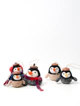 Perfect for beginners to tackle, these felted penguin ornaments by Penfelt Studio wear acorn caps.