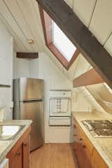 The updated kitchen receives natural light via a skylight, and certainly feels like it could be the galley on a boat.