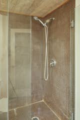 The updated shower features penny tiles.&nbsp;