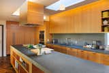 The upgraded, expanded kitchen is illuminated by natural light from new skylights above.&nbsp;