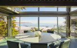 Full-height walls of glass open the interior to sweeping ocean vistas. 