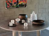 Atop the aluminum table and chair by Green River Project LLC are clay vessels by Johnny Ortiz and glass vessels by Ritsue Mishima.&nbsp;