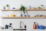 Ceramics for sale in the kitchen include yellow pasta bowls by Domenic Frunzi and the standout checkered every day mugs by local artist Athena Witscher.