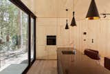 Pendant lighting brightens the wood-paneled kitchen.