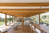 The open-plan living/dining space showcases the structure’s use of locally sourced eucalyptus.