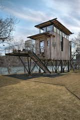 Set atop stilts designed to resemble tree branches, the tree house is clad in reclaimed Douglas fir and mirrored panels that reflect the surroundings.&nbsp;