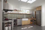 Kitchen, Granite Counter, Metal Counter, Wood Cabinet, Concrete Floor, Glass Tile Backsplashe, Recessed Lighting, Range, Drop In Sink, Refrigerator, and Range Hood  Photo 7 of 15 in Shotwell Residence by Todd Davis Architecture