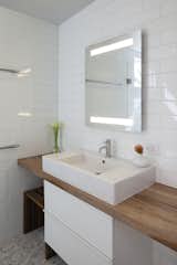 Bath Room, Wood Counter, Accent Lighting, Vessel Sink, Ceramic Tile Floor, Subway Tile Wall, and Ceramic Tile Wall  Photo 9 of 15 in Shotwell Residence by Todd Davis Architecture