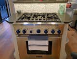 Five burner chef's stove top, storage, and bar seating are