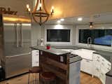 Full-size refrigerator and five burner chef's kitchen, 19' of quartz composite counter tops, bar seating area