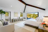 Rivaling a resort-like experience, this Santa Barbara bedroom provides a dreamy retreat to outdoor recreation. The NanaWall opening glass wall features FoldFlat technology that provides a barrier-free opening to the massive pool and mountain views awaiting outside.  