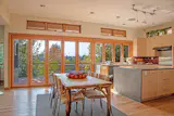 This Seattle kitchen features a kitchen transition that immediately transforms the space into an outdoor dining area. When closed, the NanaWall WA67 clad system offers the elegant aesthetic of wood and the protective performance of aluminum.