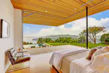 As if there were not any walls at all, this mid-century modern California residence opens up its bedroom to enviable views of the Golden Gate Bridge. The open corner design offered by a single track sliding NanaWall system that stacks out of the opening provides a one of a kind lounging experience by eliminating walls and opening up to majestic sunsets.