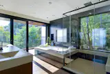 Glass surrounds this Sausalito bathroom, from the shower to the NanaWall operable glass wall that opens up to the balcony. Being near the San Francisco bay, this residence enjoys views of the water and Golden Gate Bridge—talk about a bath with a view.