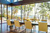 This West Virginia Home seamlessly blends with the outdoors with vanishing NanaWall minimal sliding glass walls.  Finding design inspiration in the withering Fall leaves outside, the interior furniture and décor match the warm colors of the horizon.