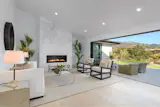 Rivaling a resort-like experience, this Santa Barbara living room boasts multiple glass wall openings that effortlessly transitions interiors to outdoor recreation. The vaulted ceilings and contemporary fireplace deliver modernized design features to this ranch-styled home, but nothing rivals the view provided by the NanaWall system.