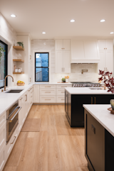 Contemporary kitchen with white cabinets and floating shelves