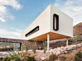 The white stucco volume stands out amid the rocky terrain of the Franklin Mountains near El Paso.
