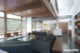 Designed for sites with a pronounced primary viewing direction, such as lakefront or hillside properties, this home’s great room extends out onto a covered outdoor terrace.  A fireplace at opposite ends bookends this expansive indoor/outdoor living area.

A light well stretches the length of the great room, bringing in natural light from several directions.

Exposed post and beam structure is reserved for the shared main level spaces, bringing the warmth of wood into this bright open home.

The house features 3 bedrooms and a loft office/family room, along with 4 baths, a screened porch, and a roof deck, making single level living possible. 

#turkeldesign #prefab #dwellprefab #residential #modern #design