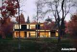 Designed for a hillside site or lakefront property, this modest, efficiently designed home allows multiple spaces to share in primary views.

A deep covered porch allows for ample sheltered outdoor living while the screened porch, accessible through a 12 foot retractable wall of glass, allows for seamless flow from dining area to screened sitting area.

The living and dining areas share in the light well that fills the kitchen with light via the loft above.

The house features 3 bedrooms and a loft office/den, along with 3 baths and a screened porch, making single level living possible. 

#turkeldesign #prefab #dwellprefab #residential #modern #design
