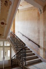 The House of Unger – interior
Author: Barbora Hora, Jan Hora, Jan Veisser / ORA architects
Address: Rooseveltova 836/6, Znojmo, 669 02, Czech Republic
Realization: 2012-2015
Layout: 120 m2
The house of builder Johann Unger who significantly influenced architecture during the turn of 19th century has been found in well-preserved form. In the course of the time it has not changed, the most of the elements were preserved - such as windows, doors, cement tiles, stucco, ironwork... Although the time was passing by, the house has found a symbiotic relation with it. It has been dilapidated as the result but nevertheless all its beauty is lasting.
In this case we can prove that the absence of resources for reconstruction can bring positive influence. Lot of these houses were destroyed during communist regime. There were many layers that covered the most valuable part of the house. Once we started to remove them we discovered the limits what we were dealing with. It was important to adapt the house for the contemporary comfort of living. Primarily it meant to implement electric installations, piping, heating etc. Because of the requirement was at least to interfere with existing constructions, the ceilings and floors were not touched whatsoever. On roughly scraped walls emerged impressive paintings. We kept them. All of these original textures and motives are complemented by pure white colour of plaster which brings composure in the context of lavish space.
The cellar is lightened by new windows, walls are covered with new plaster without final coat of paint. The space is monochromatic, ascetic. It serves as the working area. Living in an old house may entail some difficulties, however, overcoming them has its worth. Because it gives us many rewards. We are always talking about mutual respect of the house and its residents. New house can't be so generous. We work here. We live here.