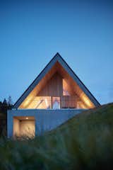 Exterior, Concrete Siding Material, House Building Type, Gable RoofLine, and Wood Siding Material  Photo 18 of 23 in This Mountain Hideaway in the Czech Republic Burrows Into a Meadow from Weekend House in Beskydy