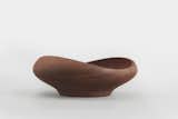 FJ Bowl - SIMPLE DESIRE

The FJ Bowl is the smallest of the sought-after teakwood bowl series that Finn Juhl designed in 1951. It features the characteristic blend of organic shapes and balance between wood, form and geometric measurements that made Juhl famous. By contrasting the undulating pattern of the teakwood with the rim, Juhl uses design to further reveal the natural properties of the material at hand: depending on what angle you look at it from, the bowl changes shape, creating new relationships at every turn while slowly growing on you.

------

Material: Handmade in teak wood - Dimensions: H 5 cm D 15 cm