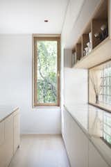 Kitchen, Wood Cabinet, Recessed Lighting, Light Hardwood Floor, White Cabinet, and Engineered Quartz Counter  Photo 5 of 16 in Verandah Place Townhouse by Space4Architecture