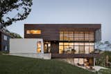 Exterior, Metal Siding Material, Flat RoofLine, Concrete Siding Material, Wood Siding Material, Glass Siding Material, House Building Type, and Stucco Siding Material Lakeside View  Photo 1 of 9 in Modern Lodge by KEM STUDIO