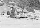 Driftwood shelter built by hippies and surfers on Agate Beach, Bolinas, California during summer 1971.  Photo by Walter Rawlings