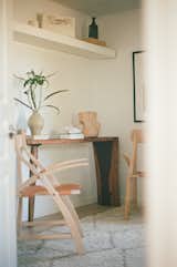 A table designed by Charlotte and made by Delta Millworks and chairs by Sean Knibb furnish the office.
