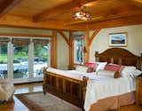 The Timber Framed Master Bedroom has Direct Pool Access  Photo 15 of 17 in Yellow Brook Farm House by Timberpeg