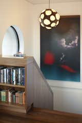 A close up detail of the built-in bookcase at the top landing of the stair.  This photo shows how 1/8" reveals are used to subtly express how the individual pieces are joined on site.