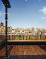 Looking out from the penthouse addition across the teak deck to the wonderful rooftop texture of the East Village.  A Cor-Ten planter with built-in teak bench forms a screening element to provide privacy from surrounding neighbors.  Photo 1 of 9 in East Village Penthouse & Roof Garden by pulltab