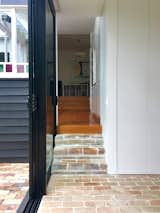 Variously finished in brick and timber, the scheme incorporates three interior levels and two exterior levels, heightening the sense of the landscape extending inside the building and vice versa.