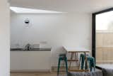 Looking from the dining area adjacent to the garden, the triangular roof-lights provide ample daylighting to the deep-plan areas of the scheme, and define soft edges to the different zones of the open-plan space.