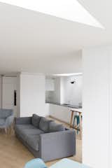 Looking from the dining area adjacent to the garden, the triangular roof-lights provide ample daylighting to the deep-plan areas of the scheme, and define soft edges to the different zones of the open-plan space.