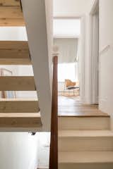 The open-riser staircase recalls the Stack artworks of Donald Judd, but in timber to match the floor of the original Victorian house.