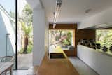 A mirrored wall appears as another incision in the building, and visually doubles the frameless openings in the interior and exterior.