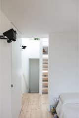 Held in door pockets, frameless interior doors enable the entrances to enclosed rooms to also appear as incisions to the interior of the building. 