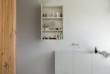A concealed bathroom cupboard appears as only an incised rectangular line in the bathroom wall when closed.