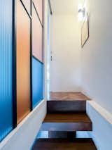The staircase references the Stack sculptures of Donald Judd, while polychromatic guarding recalls the lead-light original front door.