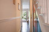 Concealed fire doors make the minimally altered ground floor feel more open-plan, while new frameless glazing to the rear elevation creates an art-like framed view of the garden.