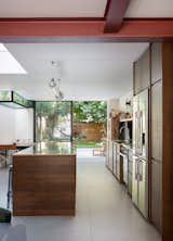 Views out of the extension are mediated by four different types of aperture—a recessed rooflight, an inverted rooflight, frameless gazing, and a clear opening when the doors are open. The view is then further shaped by the garden fences, and storage unit, which frame a view of the canal.