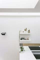 A dining area is defined by the termination of the kitchen units, and a rooflight, which together create soft edges to this portion of the open-plan space.